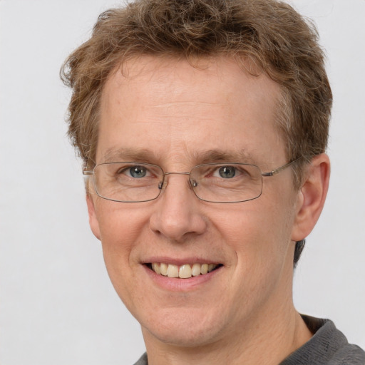 Joyful white middle-aged male with short  brown hair and brown eyes