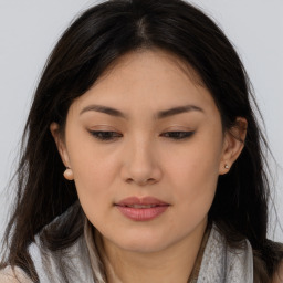 Joyful asian young-adult female with long  brown hair and brown eyes