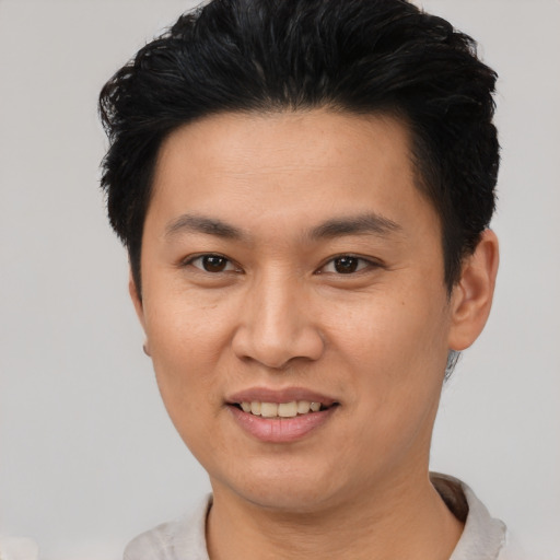 Joyful asian young-adult female with short  black hair and brown eyes