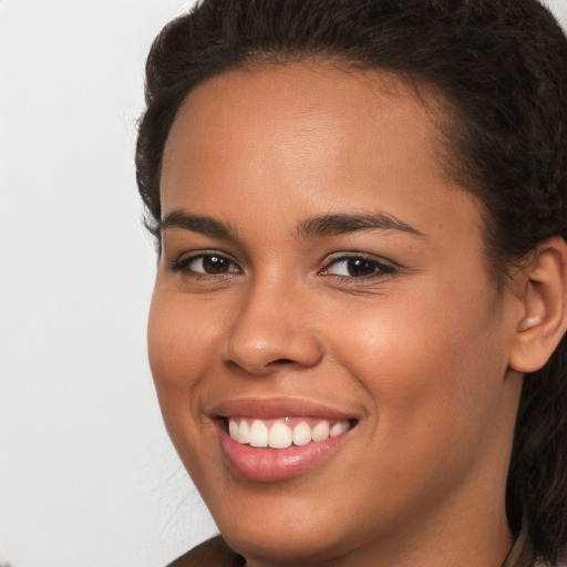 Joyful white young-adult female with long  brown hair and brown eyes