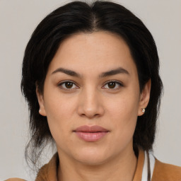 Joyful latino young-adult female with medium  brown hair and brown eyes