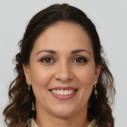 Joyful white adult female with long  brown hair and brown eyes