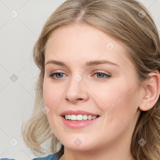 Joyful white young-adult female with medium  brown hair and blue eyes