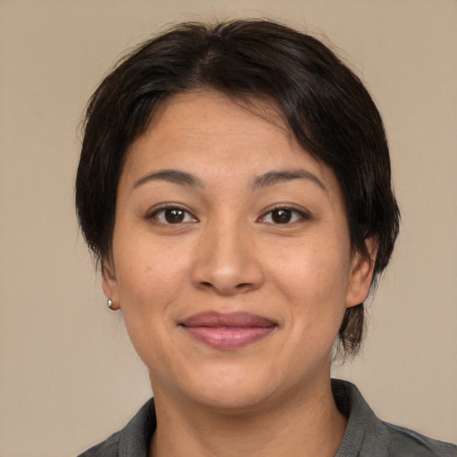 Joyful asian young-adult female with medium  brown hair and brown eyes