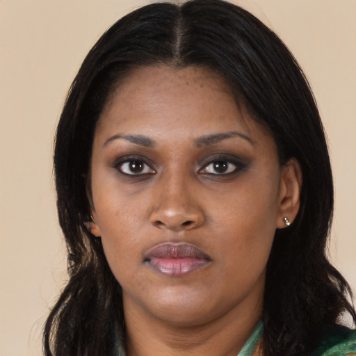 Joyful black young-adult female with long  black hair and brown eyes