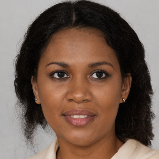 Joyful black young-adult female with medium  brown hair and brown eyes