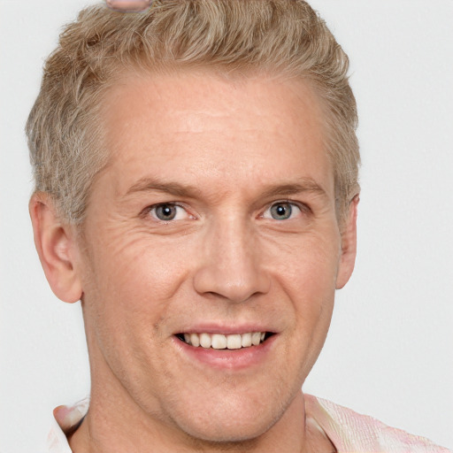 Joyful white adult male with short  brown hair and grey eyes