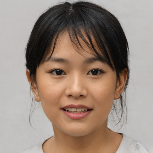 Joyful asian child female with medium  brown hair and brown eyes