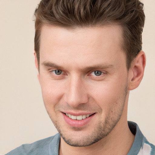 Joyful white young-adult male with short  brown hair and brown eyes