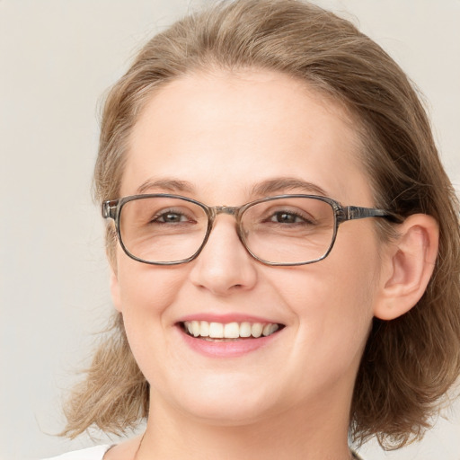 Joyful white adult female with medium  brown hair and blue eyes