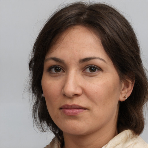 Joyful white adult female with medium  brown hair and brown eyes