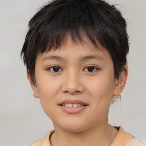 Joyful white child female with short  brown hair and brown eyes