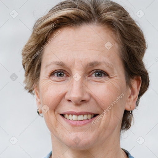 Joyful white adult female with short  brown hair and grey eyes