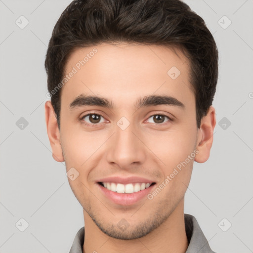 Joyful white young-adult male with short  brown hair and brown eyes