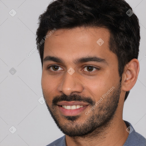 Joyful white young-adult male with short  black hair and brown eyes