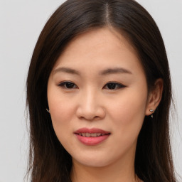 Joyful asian young-adult female with long  brown hair and brown eyes