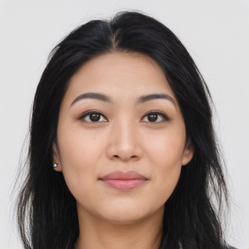 Joyful asian young-adult female with long  black hair and brown eyes