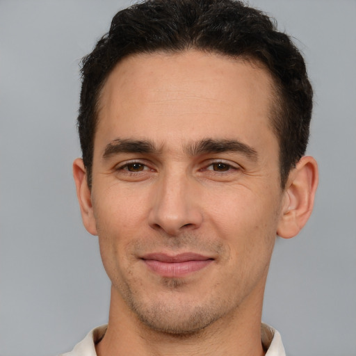 Joyful white young-adult male with short  brown hair and brown eyes