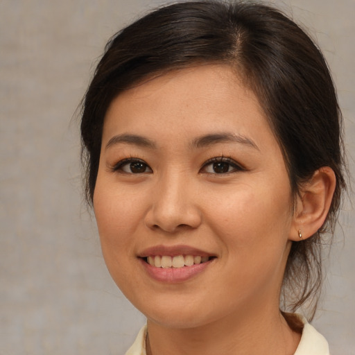 Joyful asian young-adult female with medium  brown hair and brown eyes
