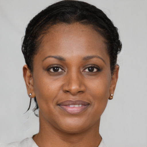 Joyful black adult female with short  brown hair and brown eyes