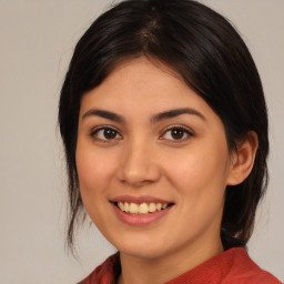 Joyful latino young-adult female with medium  brown hair and brown eyes