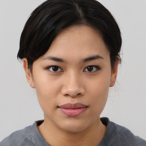 Joyful asian young-adult female with medium  black hair and brown eyes