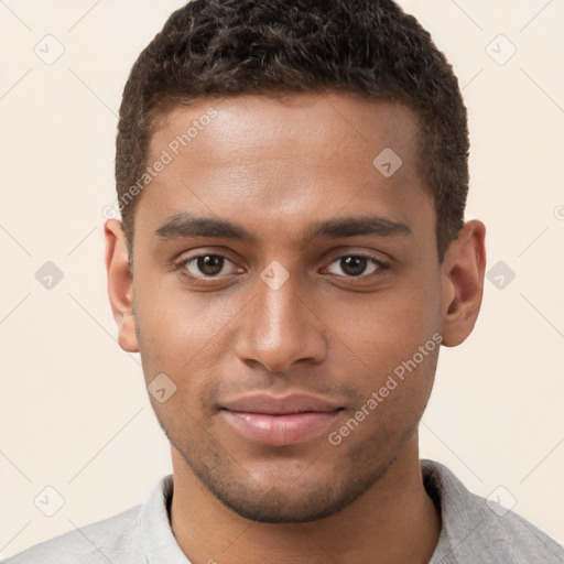 Joyful black young-adult male with short  brown hair and brown eyes