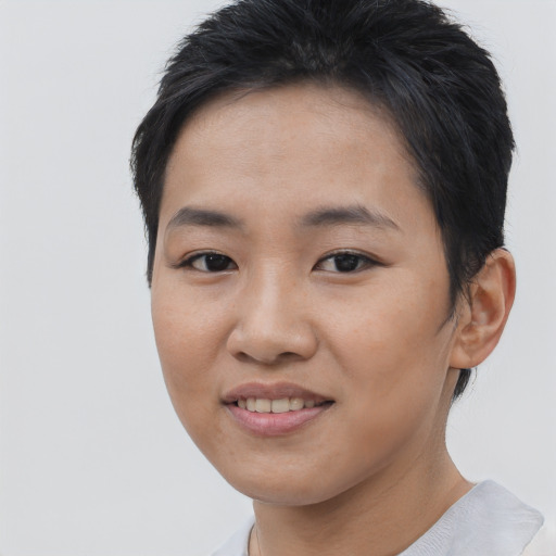 Joyful asian young-adult female with short  black hair and brown eyes