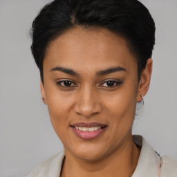Joyful latino young-adult female with short  black hair and brown eyes