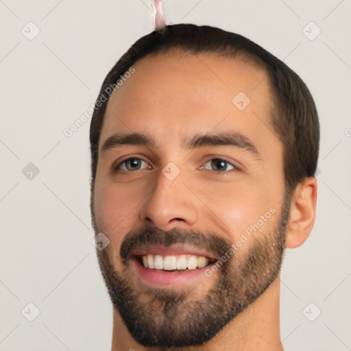 Joyful white young-adult male with short  black hair and brown eyes