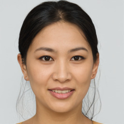 Joyful asian young-adult female with medium  brown hair and brown eyes