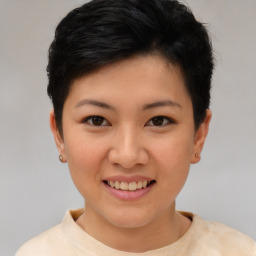 Joyful asian young-adult female with short  brown hair and brown eyes