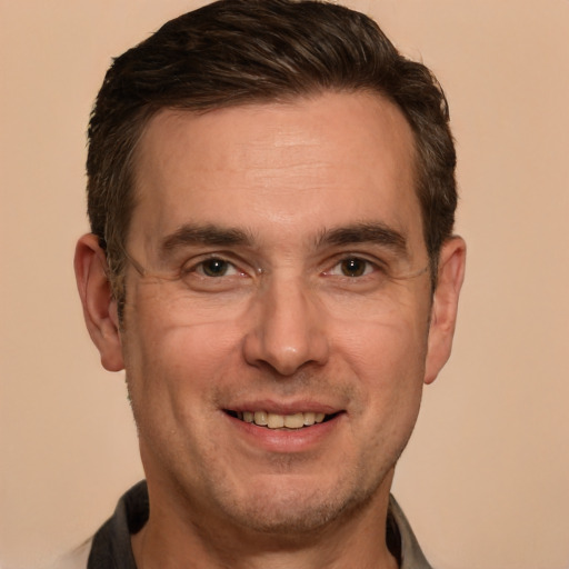 Joyful white adult male with short  brown hair and brown eyes