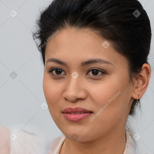 Joyful latino young-adult female with medium  brown hair and brown eyes