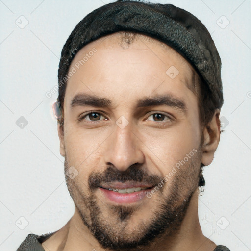 Joyful white young-adult male with short  black hair and brown eyes