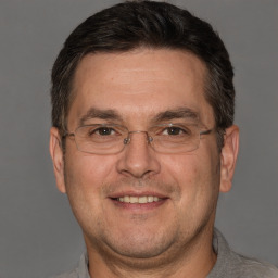 Joyful white adult male with short  brown hair and brown eyes