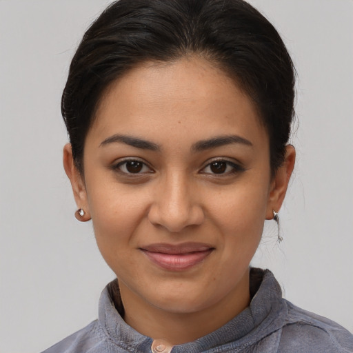 Joyful latino young-adult female with medium  brown hair and brown eyes