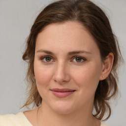 Joyful white young-adult female with medium  brown hair and green eyes