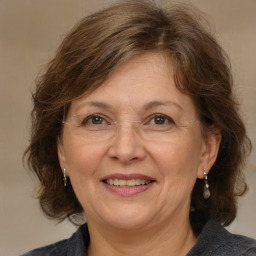 Joyful white middle-aged female with medium  brown hair and brown eyes