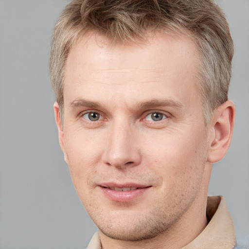 Joyful white adult male with short  brown hair and grey eyes