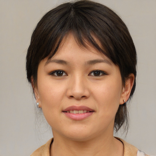 Joyful asian young-adult female with medium  brown hair and brown eyes