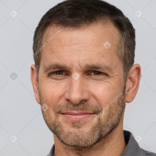 Joyful white adult male with short  brown hair and brown eyes