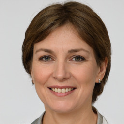 Joyful white adult female with medium  brown hair and grey eyes