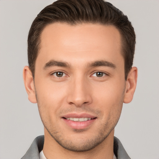 Joyful white young-adult male with short  brown hair and brown eyes