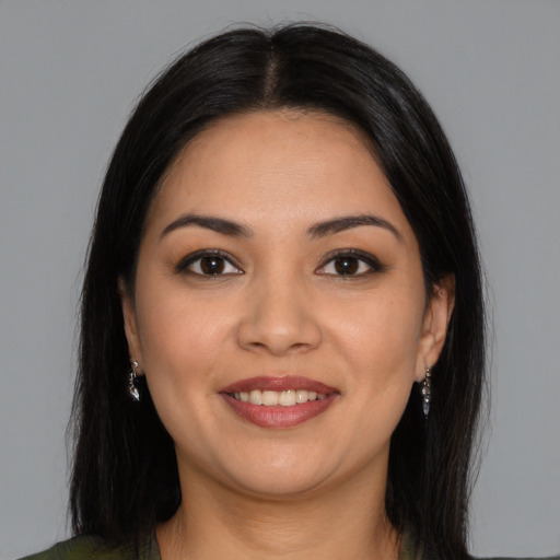 Joyful latino young-adult female with medium  brown hair and brown eyes