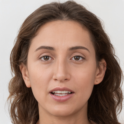 Joyful white adult female with long  brown hair and brown eyes