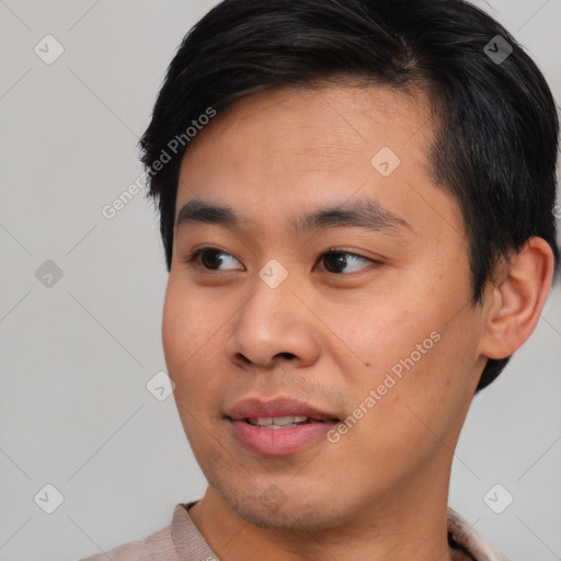 Joyful asian young-adult male with short  black hair and brown eyes