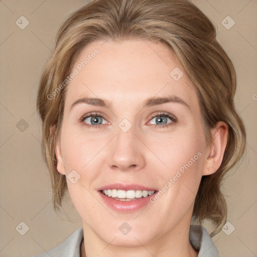 Joyful white young-adult female with medium  brown hair and blue eyes