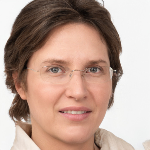 Joyful white adult female with medium  brown hair and grey eyes