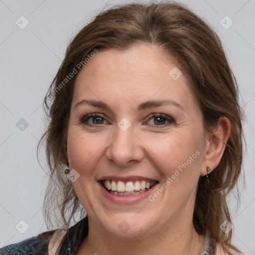 Joyful white adult female with medium  brown hair and grey eyes